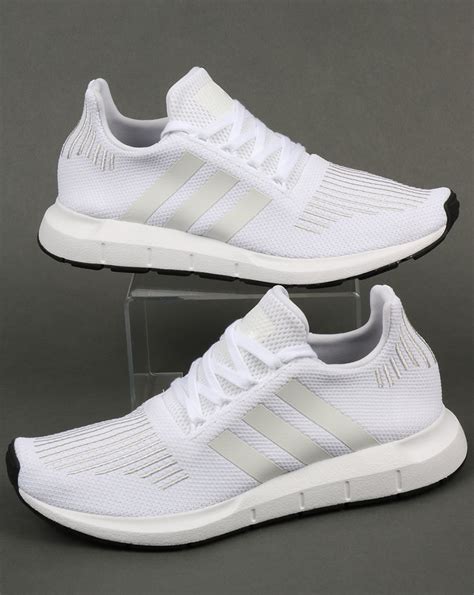 adidas white athletic shoes.